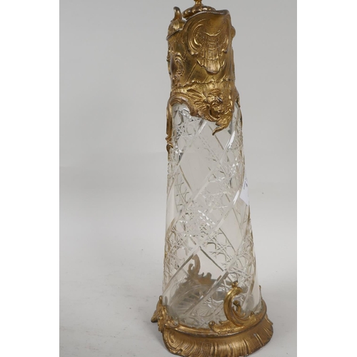 11 - A C19th gilt metal and cut glass claret jug, 12