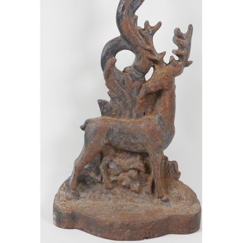 11 - An C19th cast iron door stop, in the form of a stag by a tree