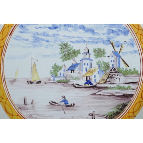 12 - An C18th/C19th polychrome Delft charger decorated with a Dutch landscape, minor losses to glaze, 13&... 