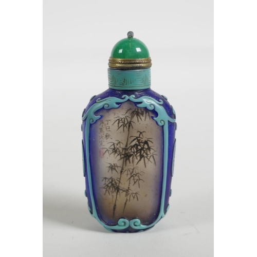 21 - A Chinese reverse decorated glass snuff bottle depicting a Chinese lady and bamboo, 3