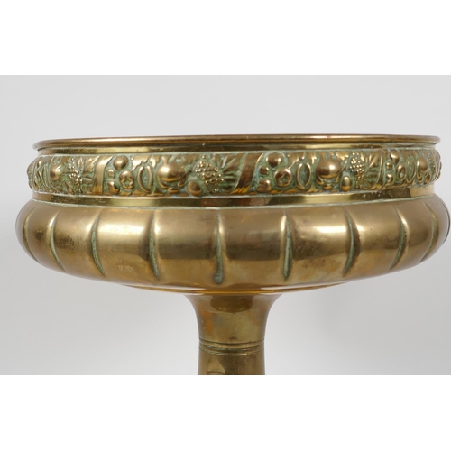 26 - A C19th brass pedestal fruit bowl, the rim embossed with various fruits, 10