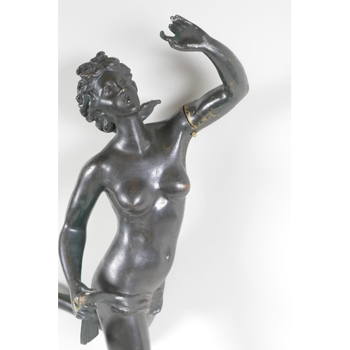 30 - A bronze figurine of a female nude standing on a wheel, 22½