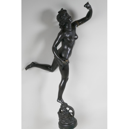 30 - A bronze figurine of a female nude standing on a wheel, 22½