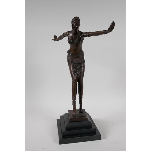 40 - A bronze figurine of a dancer, on a stepped hardstone base, after F. Preiss. 16½