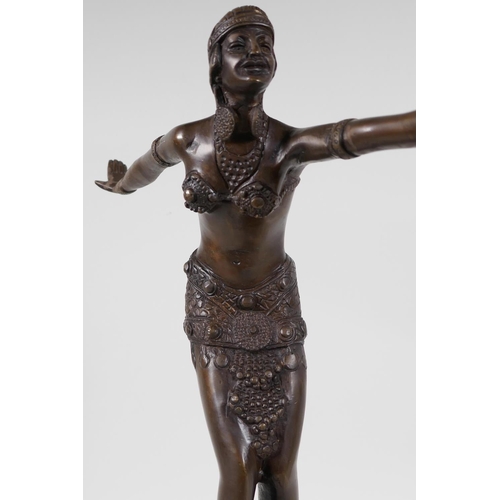 40 - A bronze figurine of a dancer, on a stepped hardstone base, after F. Preiss. 16½