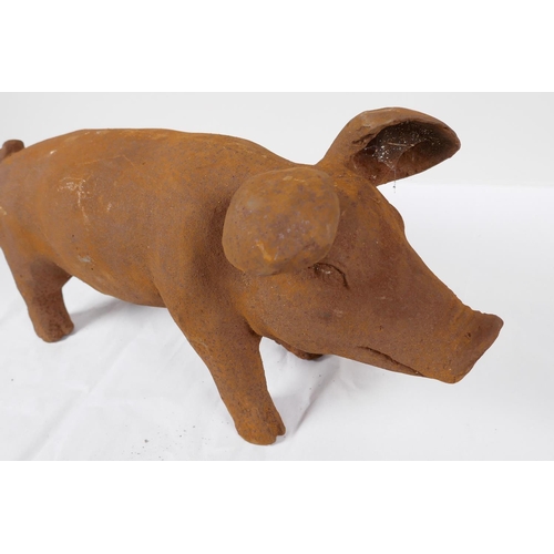 48 - A cast iron garden figurine of a pig, 17