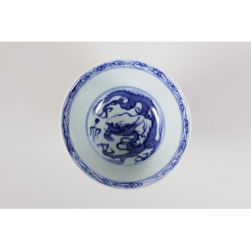 53 - A Chinese blue & white porcelain stem cup, decorated with a dragon chasing the flaming pearl, 3½... 