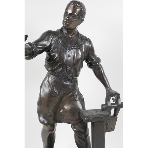 60 - A bronze figure of a metal worker, 16