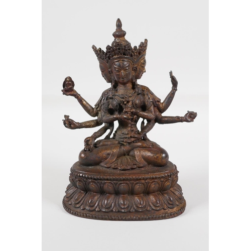 63 - A Sino-Tibetan bronze of a many armed deity, seated on a lotus throne. Carrying auspicious items, wi... 