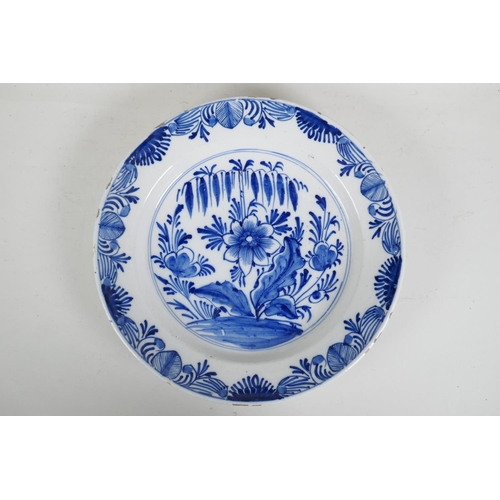 66 - An C18th/C19th Delft blue and white charger with hand painted floral decoration, 14