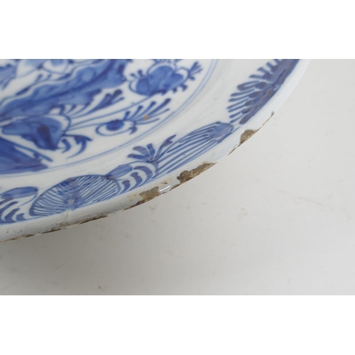 66 - An C18th/C19th Delft blue and white charger with hand painted floral decoration, 14