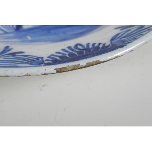 66 - An C18th/C19th Delft blue and white charger with hand painted floral decoration, 14