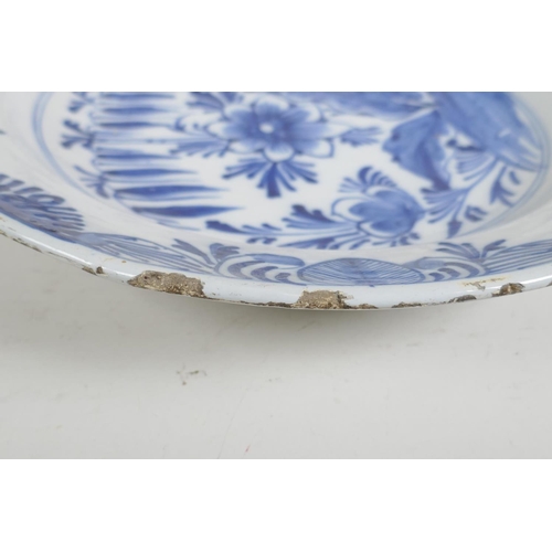 66 - An C18th/C19th Delft blue and white charger with hand painted floral decoration, 14