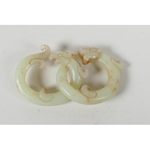 70 - A Chinese carved celadon jade link puzzle, in the form of dragons. 1½