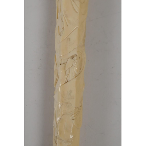 21 - A C19th Japanese carved ivory parasol handle, carved with various figures, signed with red seal mark... 