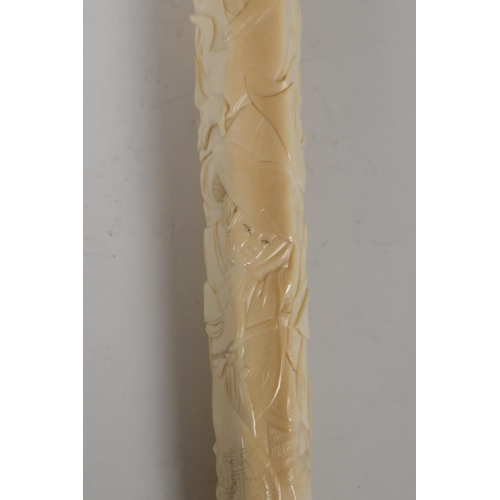 21 - A C19th Japanese carved ivory parasol handle, carved with various figures, signed with red seal mark... 