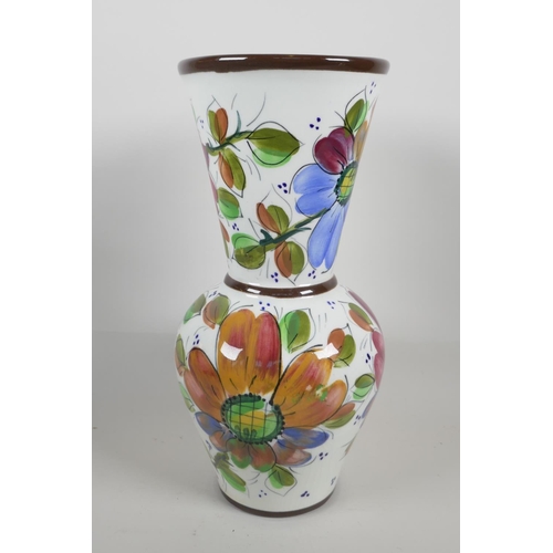 22 - A pottery trumpet vase, hand painted with flowers, 13