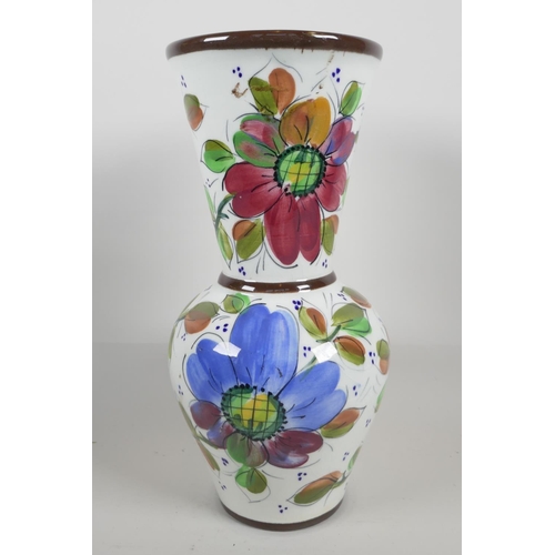 22 - A pottery trumpet vase, hand painted with flowers, 13