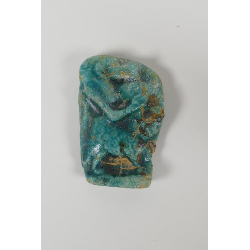 25 - An Egyptian Faience pottery Shabti and a terracotta glazed amulet of Khum, largest 4