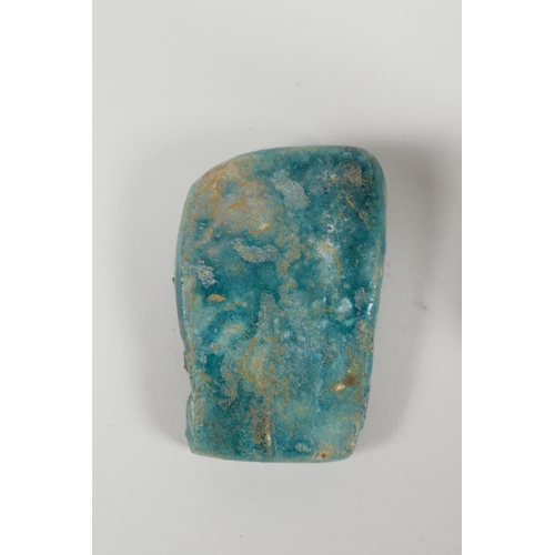 25 - An Egyptian Faience pottery Shabti and a terracotta glazed amulet of Khum, largest 4