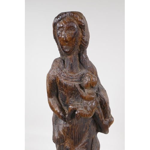 29 - An antique oak carving of the Madonna & child, 22