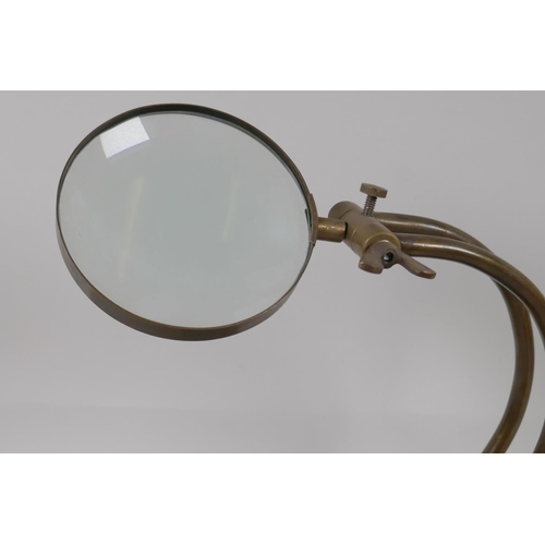 31 - A brass desk top magnifying glass on adjustable stand, 10