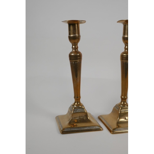 35 - A pair of brass candlesticks with pierced spiral stems and another pair of candlesticks, largest 9½