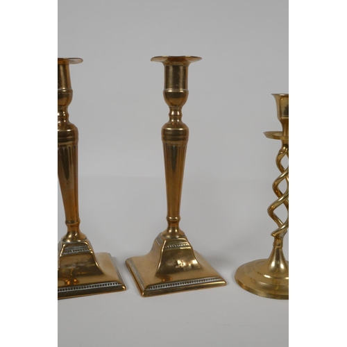 35 - A pair of brass candlesticks with pierced spiral stems and another pair of candlesticks, largest 9½