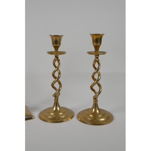 35 - A pair of brass candlesticks with pierced spiral stems and another pair of candlesticks, largest 9½