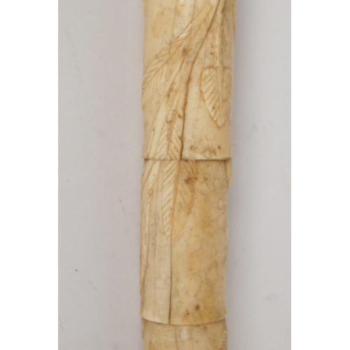 41 - A C19th Chinese carved ivory sectional dandy cane, with dogs head handle, the stem carved with scrol... 