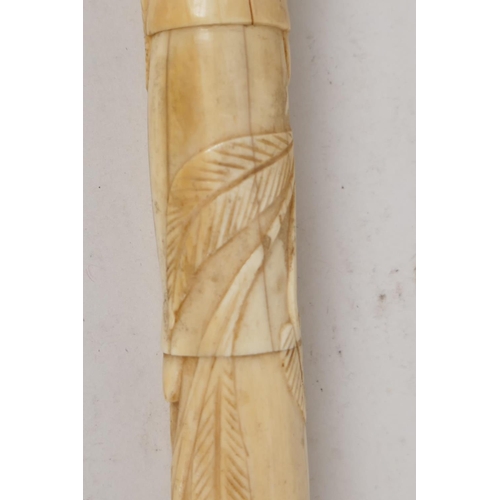 41 - A C19th Chinese carved ivory sectional dandy cane, with dogs head handle, the stem carved with scrol... 