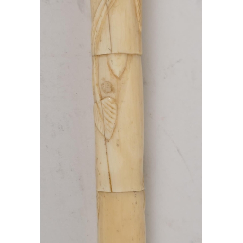 41 - A C19th Chinese carved ivory sectional dandy cane, with dogs head handle, the stem carved with scrol... 