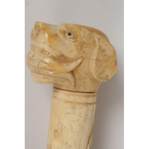 41 - A C19th Chinese carved ivory sectional dandy cane, with dogs head handle, the stem carved with scrol... 