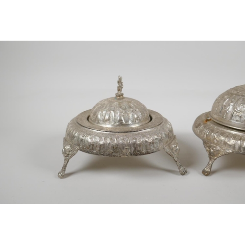 50 - An Indo Persian white metal sweet meat & bonbon dish, with raised figural decoration & tripo... 