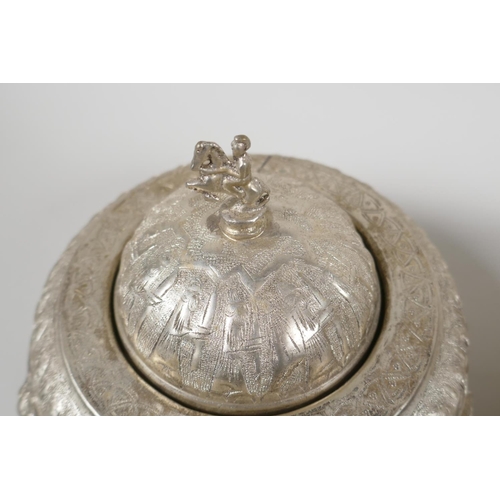 50 - An Indo Persian white metal sweet meat & bonbon dish, with raised figural decoration & tripo... 