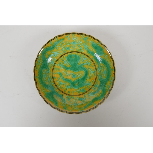 52 - A yellow ground porcelain dish with frilled rim and incised green dragon decoration, Chinese Qianlon... 