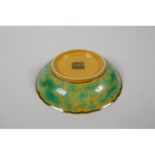 52 - A yellow ground porcelain dish with frilled rim and incised green dragon decoration, Chinese Qianlon... 