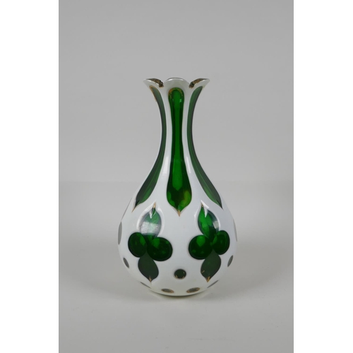 55 - A Bohemian overlaid green glass vase with gilt details, 8½