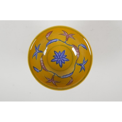 57 - A Chinese yellow ground porcelain stem bowl with red and blue floral decoration, 6 character mark to... 