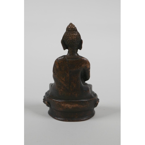 58 - A Sino Tibetan bronze figure of Buddha seated on a lotus throne, 3½