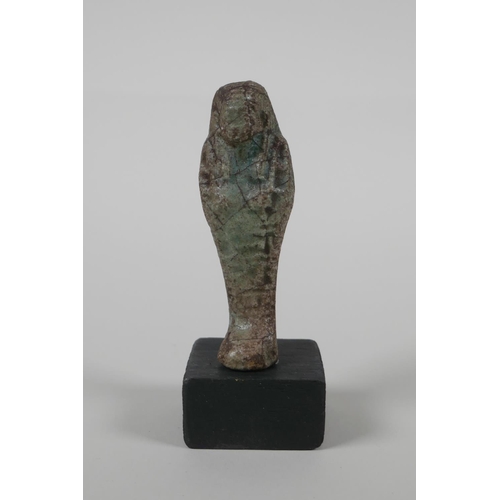 60 - An Egyptian Faience pottery Shabti and a pottery amulet of Khum, 3½