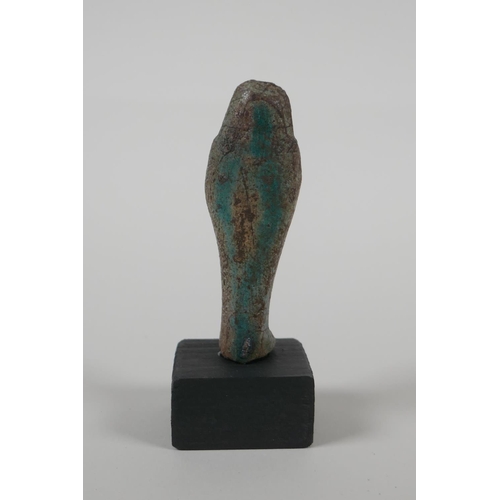 60 - An Egyptian Faience pottery Shabti and a pottery amulet of Khum, 3½