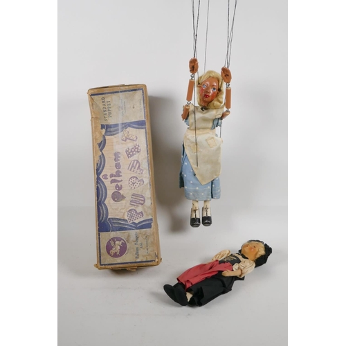 61 - An Alice in Wonderland Pelham Puppet in original box, and a girl's doll with a wire frame, puppet 11... 