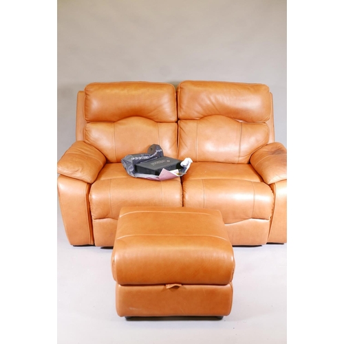 1140 - A Sofology two seater reclining leather sofa with pouffe and original care pack, 66