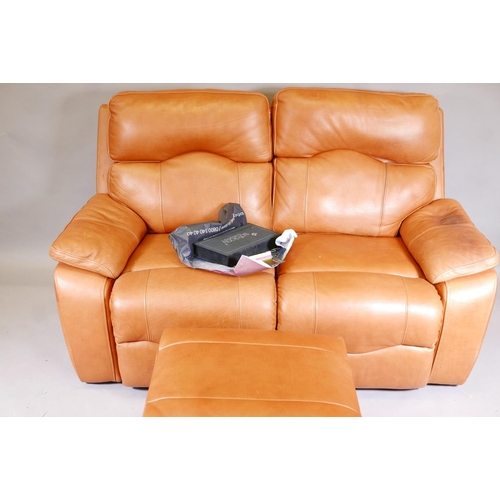 1140 - A Sofology two seater reclining leather sofa with pouffe and original care pack, 66