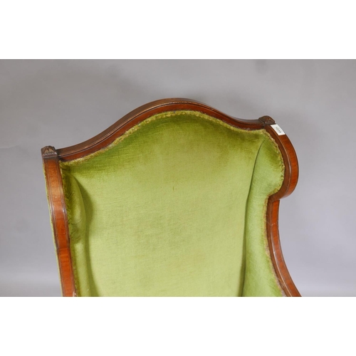 1148 - A Victorian mahogany wingback armchair with green upholstery