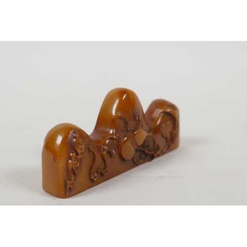 3 - A Chinese amber soapstone brush rest/seal, with carved gourd decoration, 3