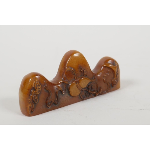 3 - A Chinese amber soapstone brush rest/seal, with carved gourd decoration, 3