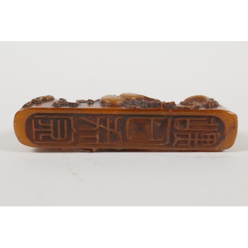 3 - A Chinese amber soapstone brush rest/seal, with carved gourd decoration, 3