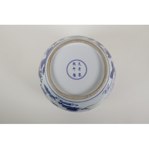 35 - A blue and white porcelain jardiniere decorated with travellers, Chinese KangXi 6 character mark to ... 